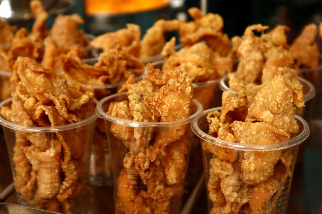 freshly deep fried chicken skin on display at a store