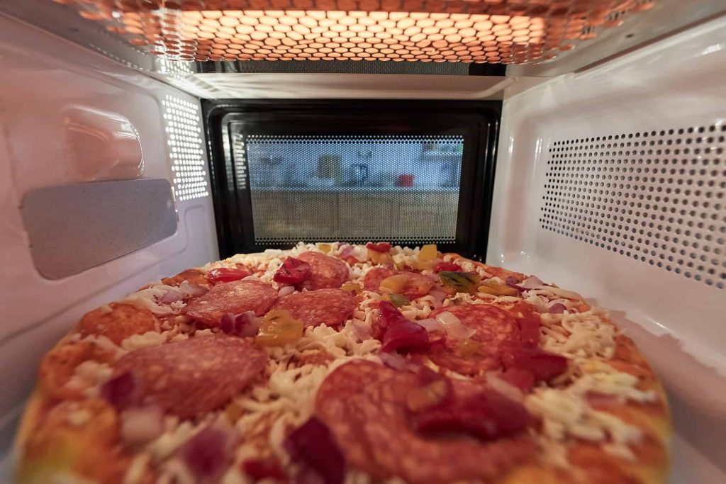 cooking frozen pizza in a microwave oven