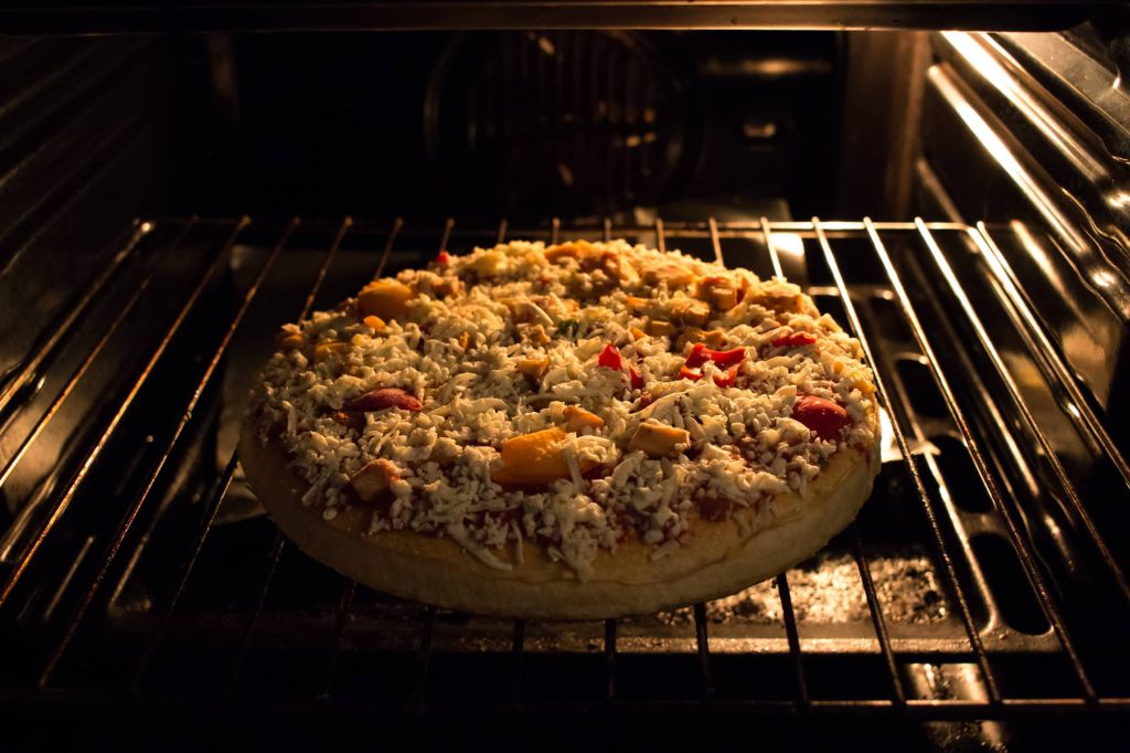 cooking frozen pizza in oven