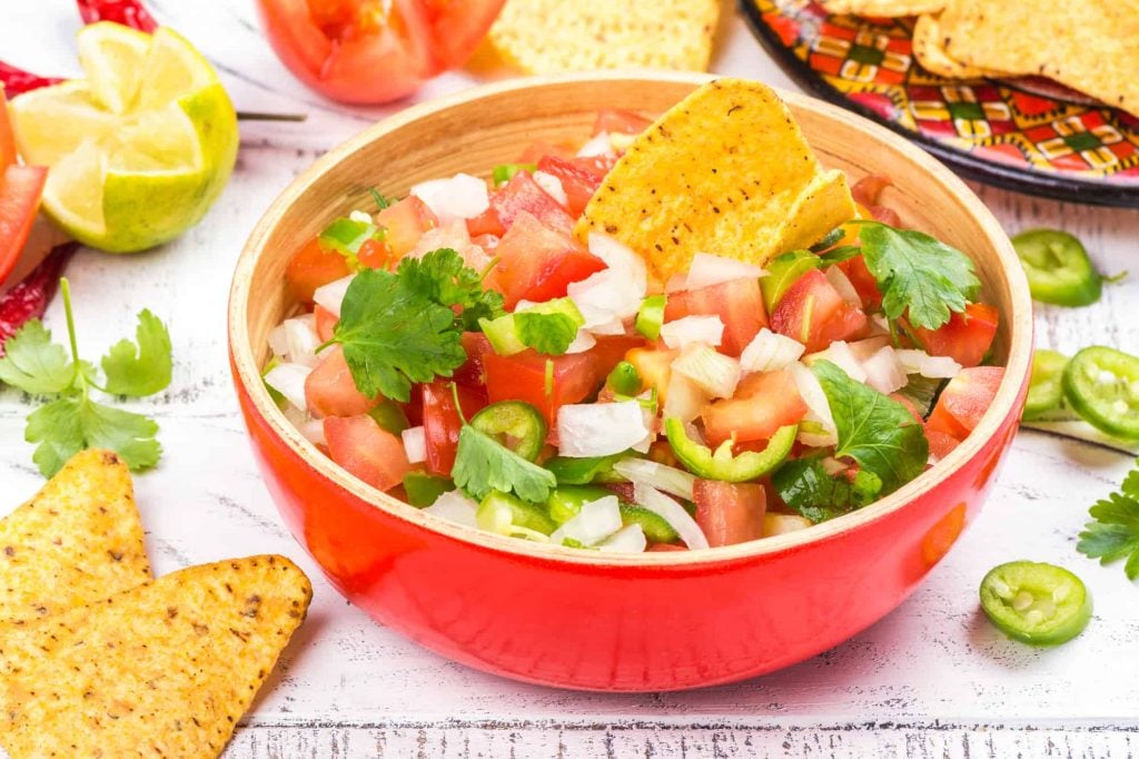 a bowl of Mexican pico de gallo with jalapenos and other ingredients